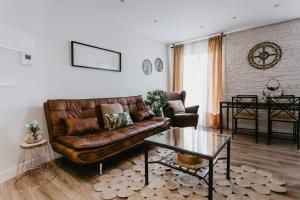 a living room with a leather couch and a table at Libertad 8 in Arnedo