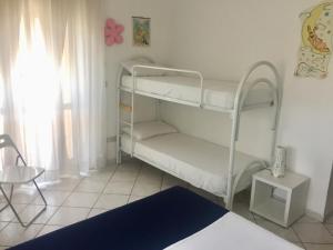 a bedroom with two bunk beds in a room at Residence Regni in Senigallia
