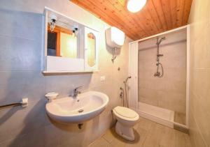a white bathroom with a sink and a toilet at Residence Dattoli in Peschici