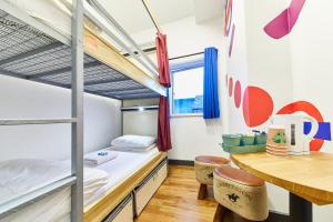 a dorm room with a bunk bed and a desk at St Christopher's Inn Village - London Bridge in London