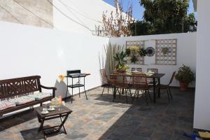 a patio with a table and chairs and a dining room at Palmeira in Faro