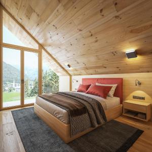 a bedroom with a large bed and a large window at HOCHoben Chalets & Mobilhomes in Mallnitz