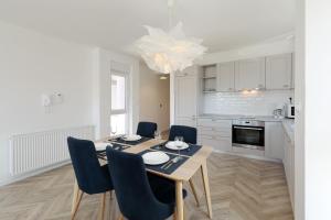 a kitchen and dining room with a table and chairs at Apartments Ivanov in Zadar