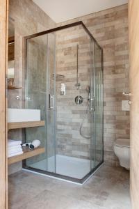 a glass shower in a bathroom with a toilet at Guesthouse Turšič in Vrhnika