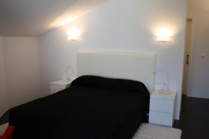 Postel nebo postele na pokoji v ubytování Hostal Tres Campanas