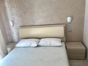 a bedroom with a bed with two pillows on it at White Sand in Ventimiglia