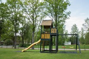 a playground with a slide in a park at Veski Guesthouse in Antsla