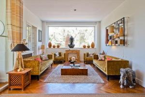 a living room with couches and a table at Hôtel La Villa Cap d’Antibes in Juan-les-Pins