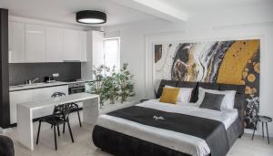 a bedroom with a large bed and a kitchen at WEST RESIDENCE APARTMENTS in Timişoara