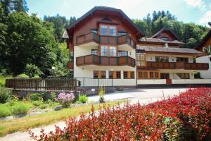 a large building with flowers in front of it at Appartement Berggasse by Schladming-Appartements in Schladming