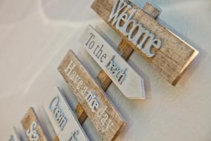 a bunch of wooden signs on a wall at Hôtel La Villa Cap d’Antibes in Juan-les-Pins