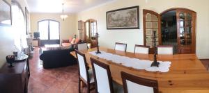 a living room with a wooden table in a room at Apartamentos na Casa São Bernardo in Alcobaça