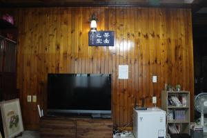 a television in a room with a wooden wall at DASAN HOUSE in Seoul