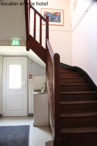 a hallway with a staircase in a house at Hôtel le Dervois in Montier-en-Der