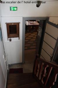 a hallway with a stairway leading to a hotel entrance at Hôtel le Dervois in Montier-en-Der