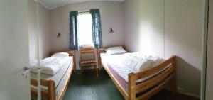 a bedroom with two beds and a window at Romsdalseggen Camping in Isfjorden