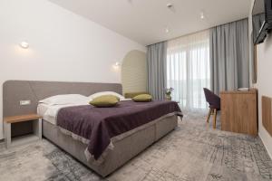 Postel nebo postele na pokoji v ubytování Hotel Nova