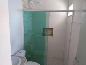 a bathroom with a shower with a toilet and a sink at Hotel Portal do Corrente in Santa Maria da Vitória