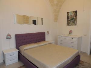A bed or beds in a room at Le Tre Meraviglie