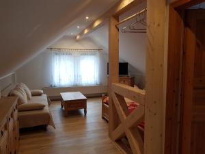 a living room with a couch and a table at Landpension Bielatal - Raum in Raum