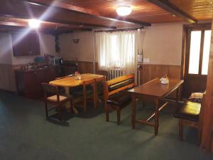 a dining room with two tables and chairs at Dzherelo in Yasinya +31 photos