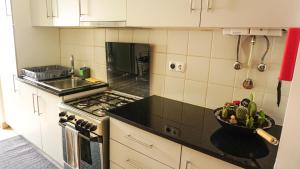 a kitchen with a bowl of fruit on the counter at Vila Relvão in Vila Franca do Campo