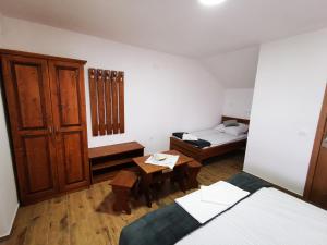 a room with two beds and a table in it at Air&Day in Vecsés