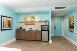 a kitchen with blue walls and a stove top oven at Margaritaville Island Hotel in Pigeon Forge