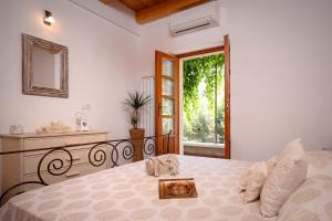 a bedroom with a bed and a mirror and a window at Villa BENEDETA-Dubovica Hvar in Hvar