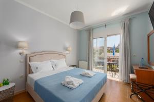 a bedroom with a bed with towels on it at Pansion Ermioni in Skala