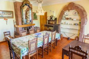 a dining room with a table and chairs and a chandelier at Quinta Infantes de Santa Maria in Alcantarilha