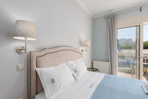 a bedroom with a bed and a window with a view at Pansion Ermioni in Skala