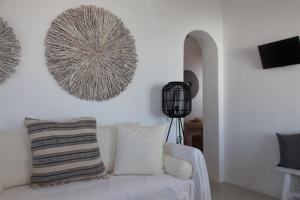 ein Wohnzimmer mit einem weißen Sofa und einer Wand in der Unterkunft Astarte Luxury Apartments in Artemonas