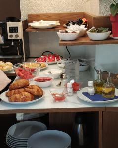 a table with plates of food on a counter at Hotel Rural Oasibeth in Frómista