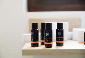 four bottles of essential oils sitting on a shelf at Hotel Rural Oasibeth in Frómista