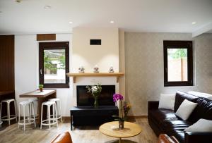 a living room with a couch and a fireplace at Hotel Rural Oasibeth in Frómista