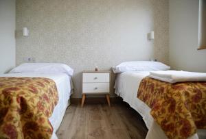 two beds sitting next to each other in a room at Hotel Rural Oasibeth in Frómista