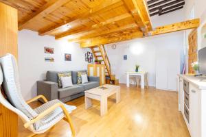 a living room with a couch and a table at Duplex Lavapies 1BD in Madrid