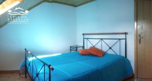 a blue bedroom with a bed with a blue sheets at Casa da Barragem in Montalegre