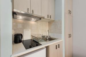 a kitchen with a sink and a counter top at Pansion Ermioni in Skala