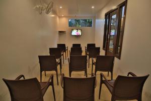 a conference room with chairs and a tv at Suvidha Ghar AC DORMITORY in Surat