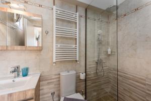 a bathroom with a shower and a toilet and a sink at Pansion Ermioni in Skala