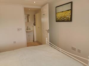 a bedroom with a bed and a painting on the wall at Executive Annex - Dunfermline in Dunfermline