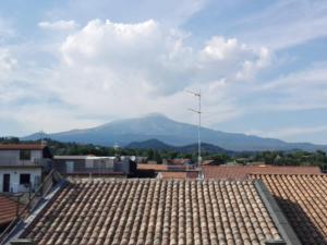 a view from the roof of a building with mountains in the background at TalialETNA Apartments in Nicolosi