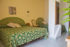 Postel nebo postele na pokoji v ubytování Hotel Grotticelle