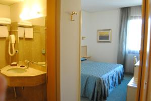 Postel nebo postele na pokoji v ubytování Hotel Bassetto