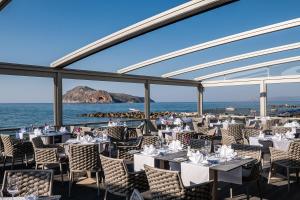a restaurant with a view of the ocean at Porto Platanias Beach Luxury Selection - Adults Only in Plataniás