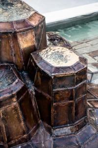 a pile of wooden boxes sitting next to a pool at Porto Platanias Beach Luxury Selection - Adults Only in Plataniás