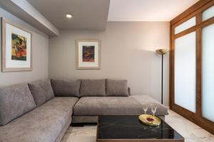 a living room with a couch and a table at Porto Platanias Beach Luxury Selection - Adults Only in Plataniás