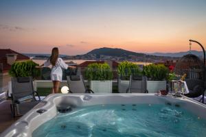a woman standing in a bath tub on a roof at Villa Muller Apartments in Split